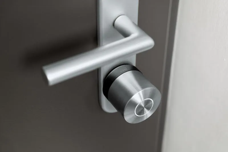 A Nuki Smart Lock Ultra mounted on the door