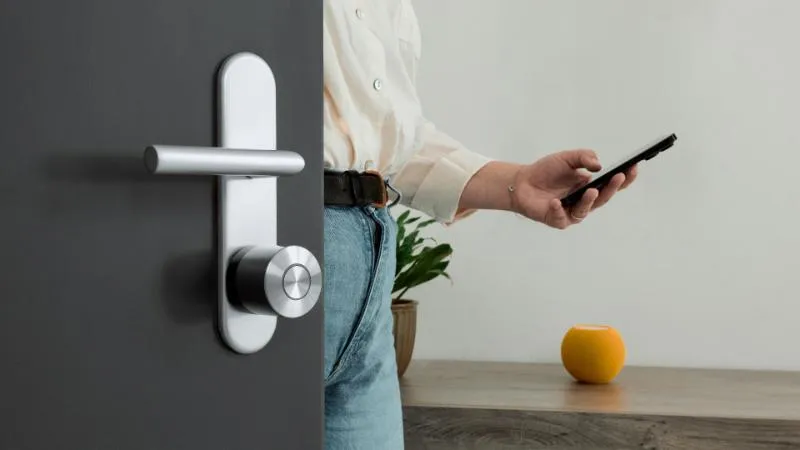 A Nuki Smart Lock Ultra being operated with a smartphone